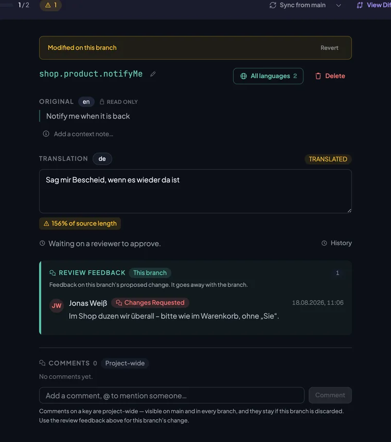 The key shop.product.notifyMe on the branch with the rewritten value Sag mir Bescheid, wenn es wieder da ist, and the reviewer’s note under Review Feedback.
